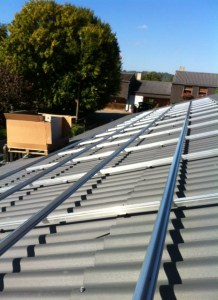 Début de la pose des modules photovoltaïques, palettes montées au chariot élévateur.